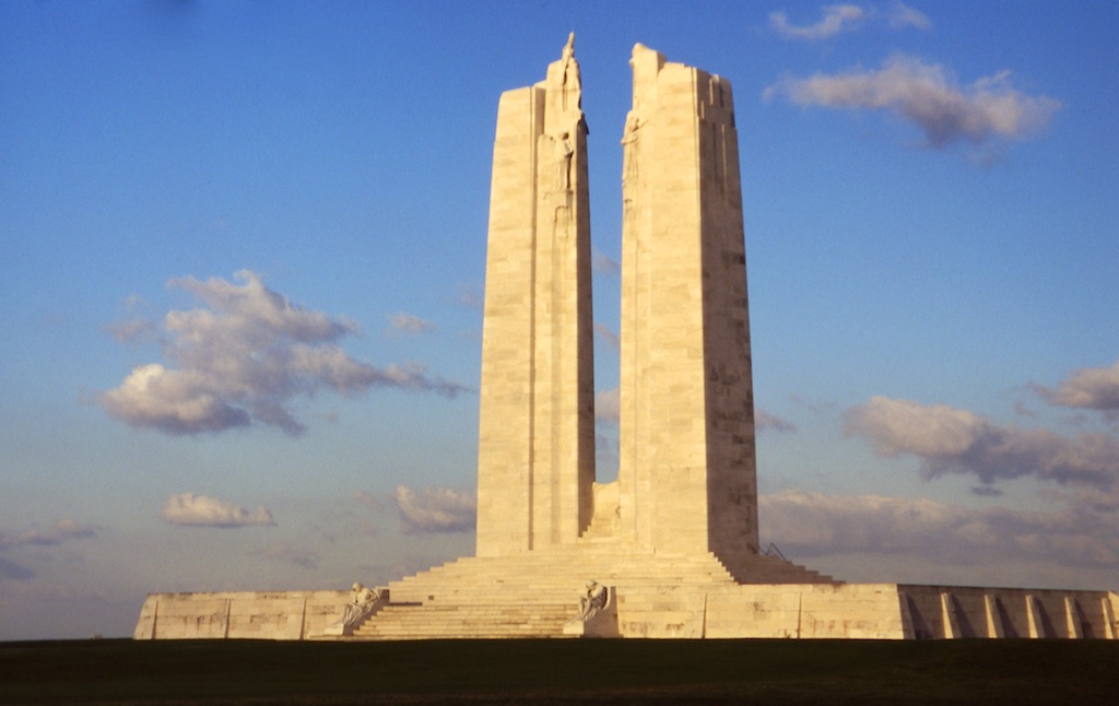 A very large monument with two pointed towers rising high from a large rectangular platform.